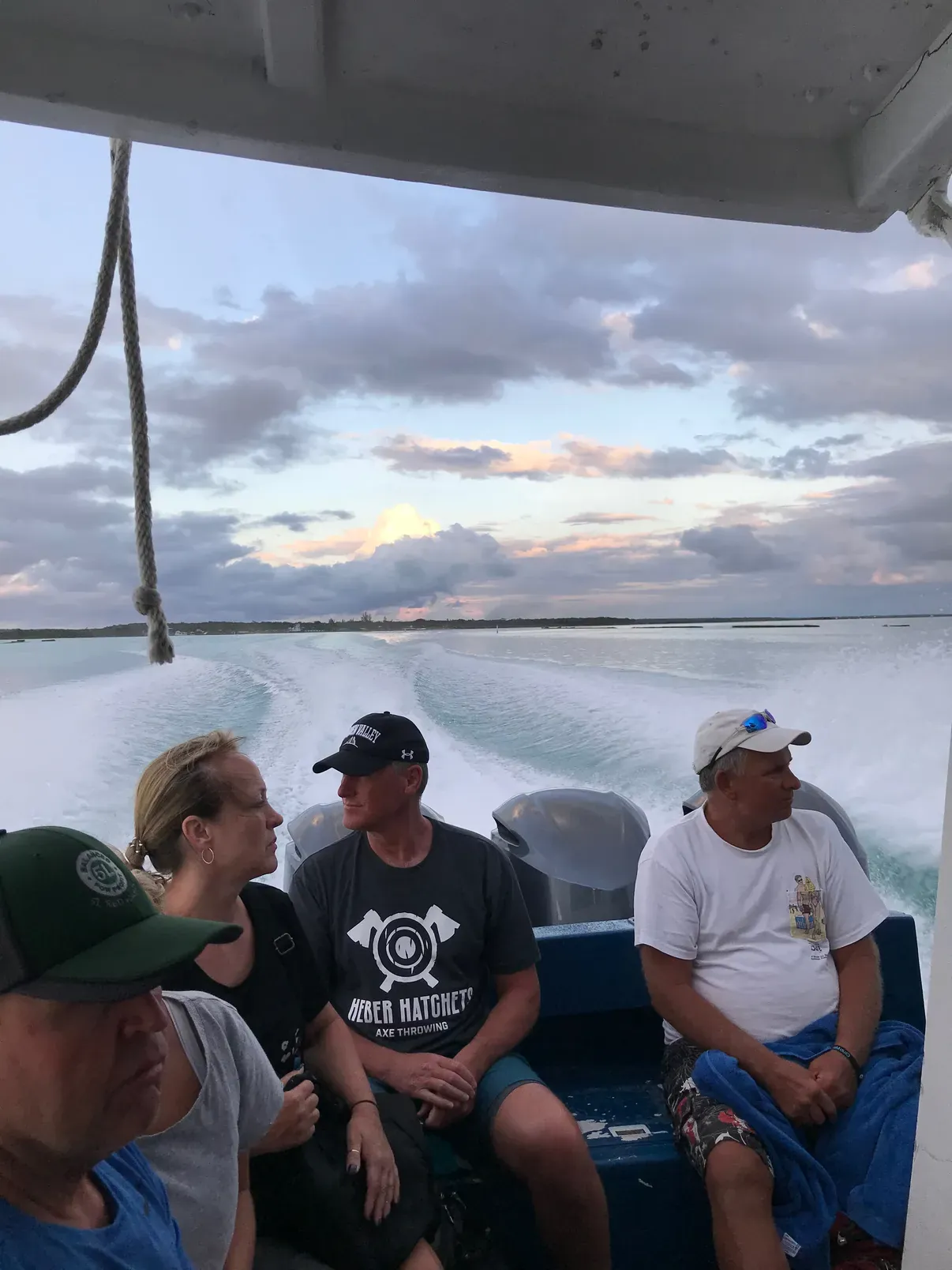 Fellow passengers on the boat back from North Caicos, golden light and calm teal water behind