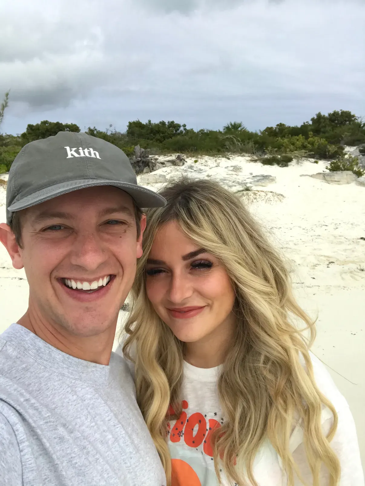 A laughing selfie on the sand, dunes and scrub behind
